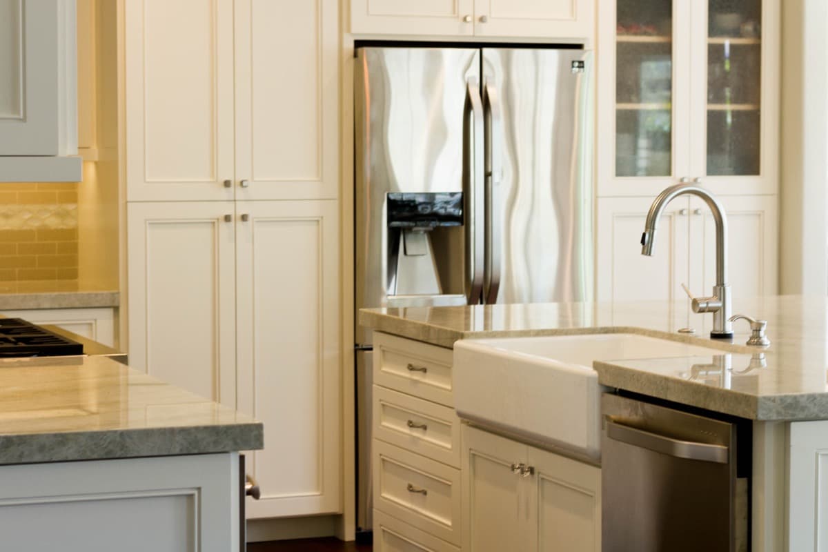 Glass-front display uppers and a farmhouse sink in the Morgan Hill kitchen