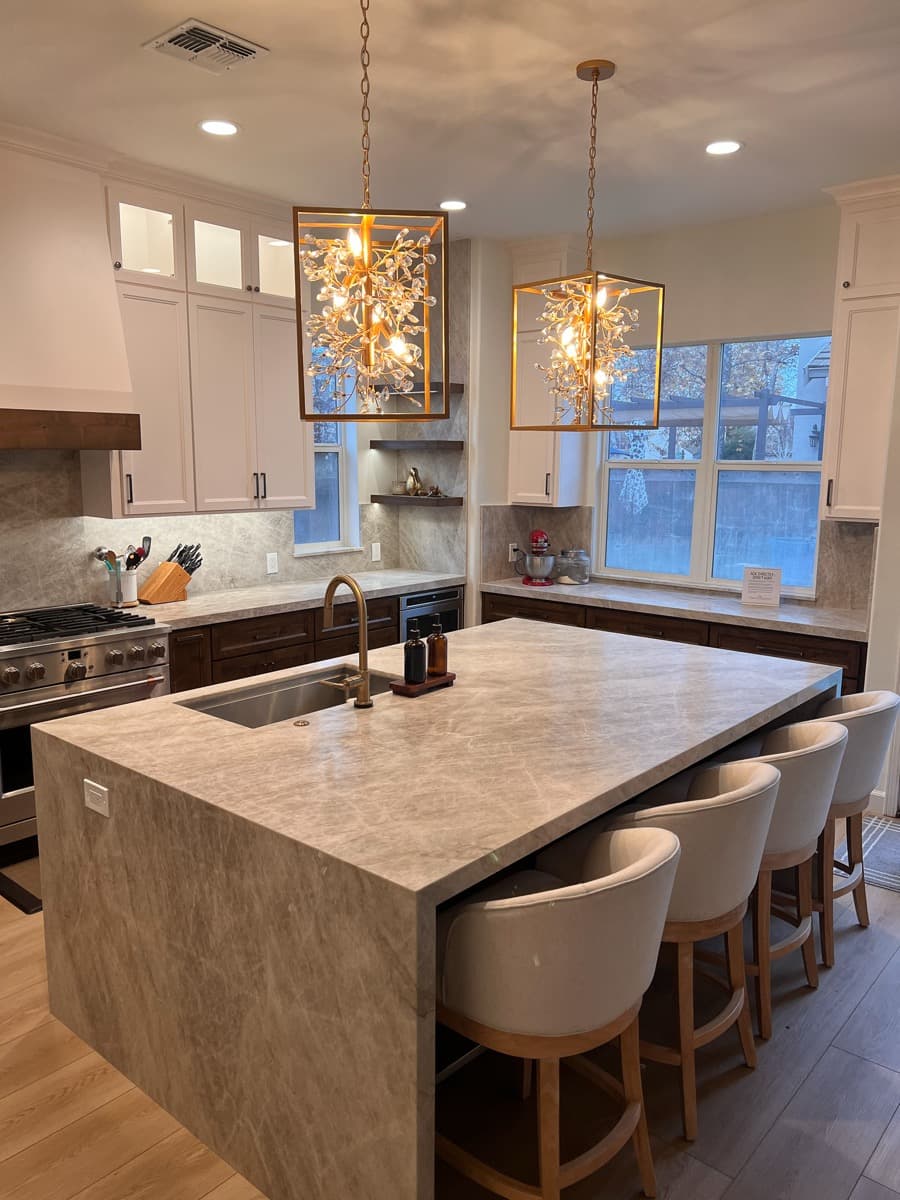 Island prep sink with brass faucet and floating walnut shelves
