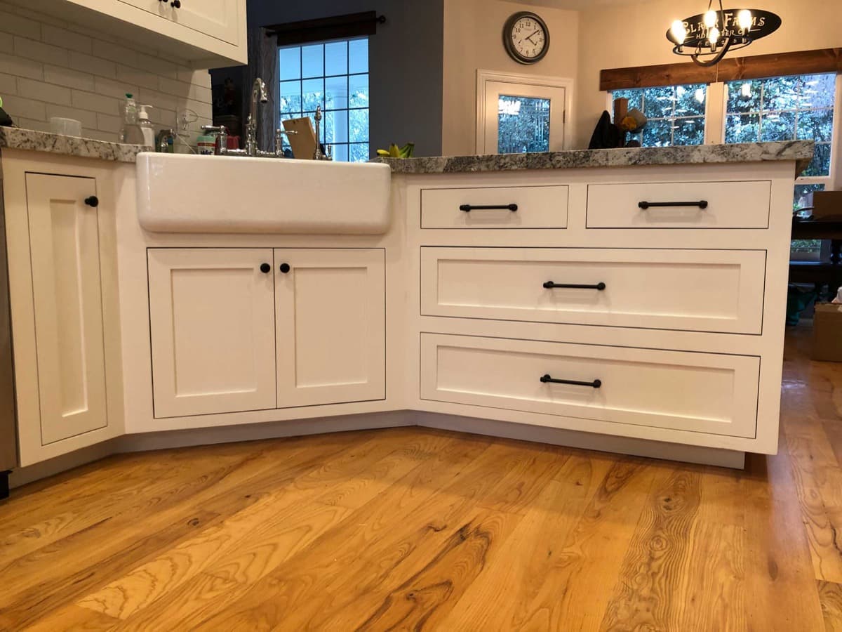 White shaker base cabinets with a farmhouse sink
