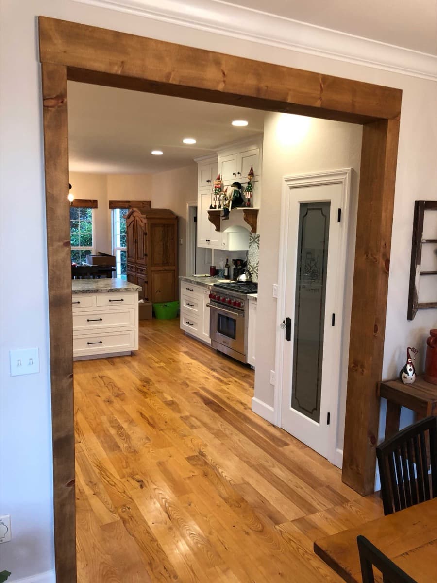 Hollister kitchen viewed through a walnut-trimmed doorway